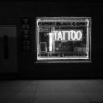 Grayscale Photo of Tattoo Neon Signage